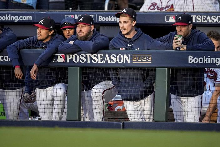 Atlanta Braves players watch play against the Philadelphia Phillies during the second inning of Game 1 of a baseball NL Division Series, Saturday, Oct. 7, 2023, in Atlanta. (AP Photo/John Bazemore)