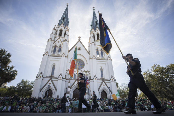 Participants carry flags past the Cathedral Basilica of St. John the Baptist while marching in the St. Patrick's Day parade, March 17, 2023, in historic downtown Savannah, Ga. Savannah, Georgia's oldest city, is planning a supersized celebration as it marks the 200th anniversary of its beloved St. Patrick's Day parade. City Manager Jay Melder says he's expecting historic crowds for the Irish-themed parade Saturday, March 16, 2024. 