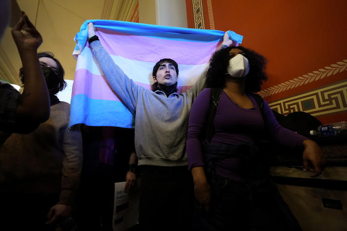 LGBTQ+ rights supporters rally in the hallway outside an Iowa House Judiciary subcommittee hearing, Wednesday, Jan. 31, 2024, at the Statehouse in Des Moines, Iowa. The rights of LGBTQ+ people continue to be in flux across the U.S. with a new flurry of developments. 