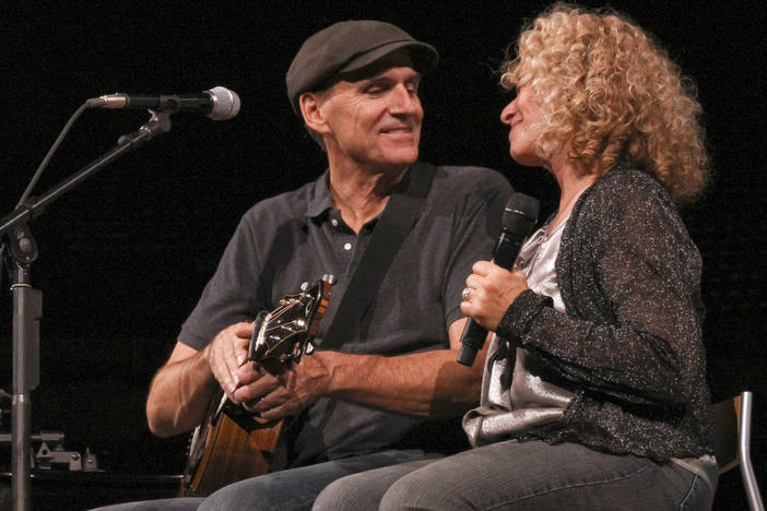 Carole King and James Taylor together on stage.