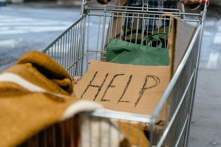 Cart with "HELP" sign.