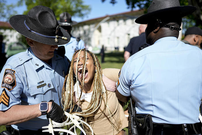 Georgia State Patrol officers detain a demonstrator on the campus of Emory University in Atlanta during a pro-Palestinian demonstration on Thursday. / AP
