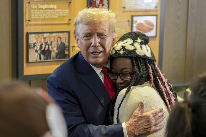 Republican presidential candidate former President Donald Trump, left, hugs Michaelah Montgomery, a local conservative activist, as he visits a Chick-fil-A eatery, Wednesday, April 10, 2024, in Atlanta. 