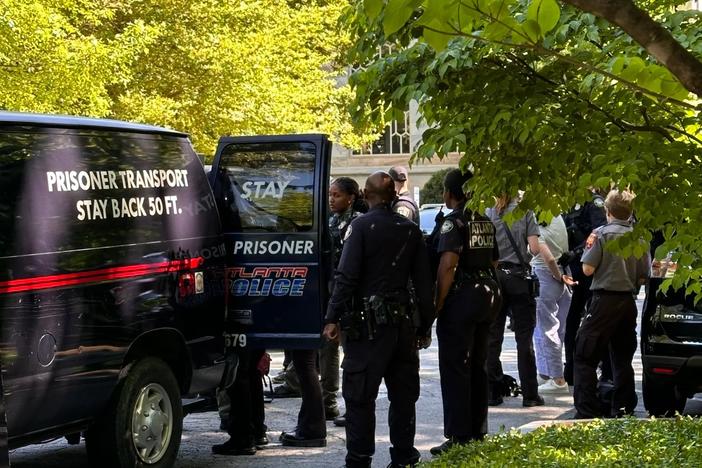 Atlanta Police load arrested protesters into the back of a van at Emory University.