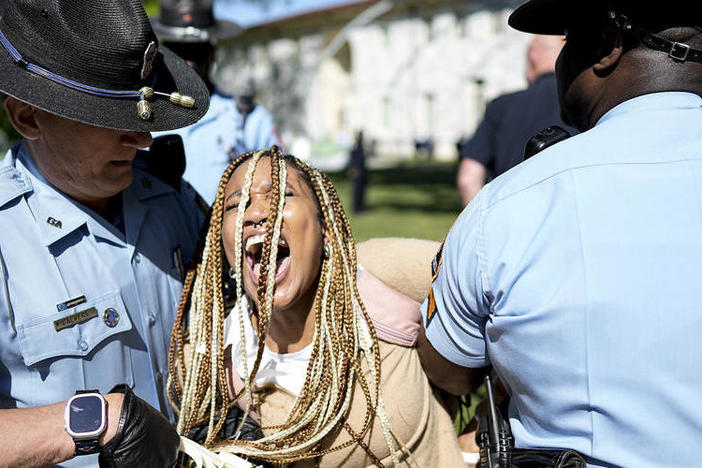 Georgia State Patrol officers detain a demonstrator on the campus of Emory University in Atlanta during a pro-Palestinian demonstration on Thursday, April 25, 2024.