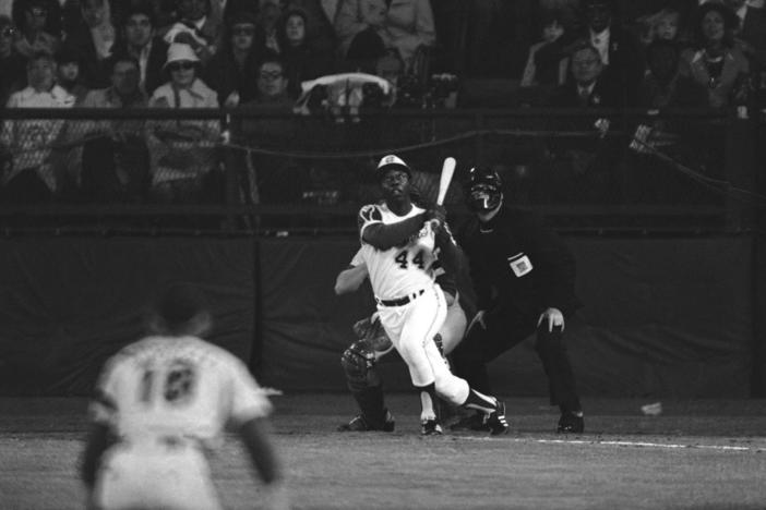 Atlanta Braves' Hank Aaron eyes the flight of the ball after hitting his 715th career homer in a game against the Los Angeles Dodgers in Atlanta, Ga., Monday night, April 8, 1974. Aaron broke Babe Ruth's record of 714 career home runs. Dodgers southpaw pitcher Al Downing, catcher Joe Ferguson and umpire David Davidson look on. Just in time for the 50-year anniversary of Hank Aaron's record 715th home run, Charlie Russo is making available video he shot of the homer. 