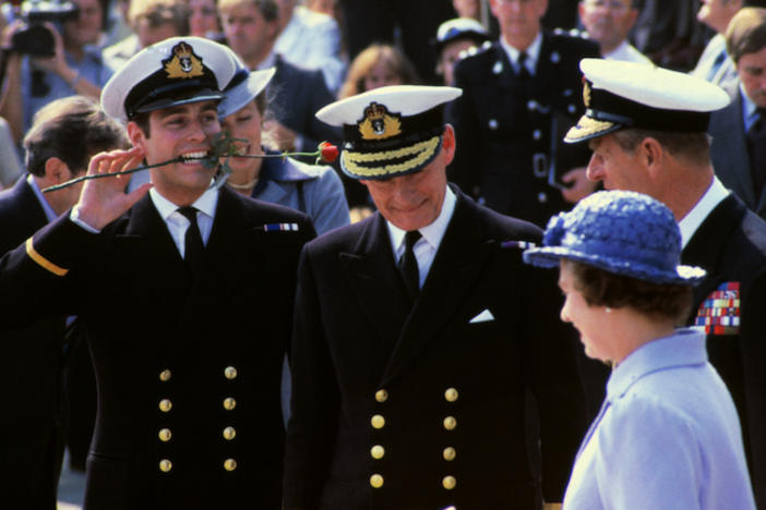Princes Andrew and Philip in naval attire with Queen Elizabeth.