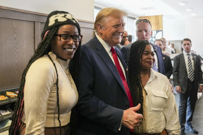 Republican presidential candidate former President Donald Trump, center, takes a photo with Michaelah Montgomery, left, a local conservative activist, as he visits a Chick-fil-A eatery, Wednesday, April 10, 2024, in Atlanta.
