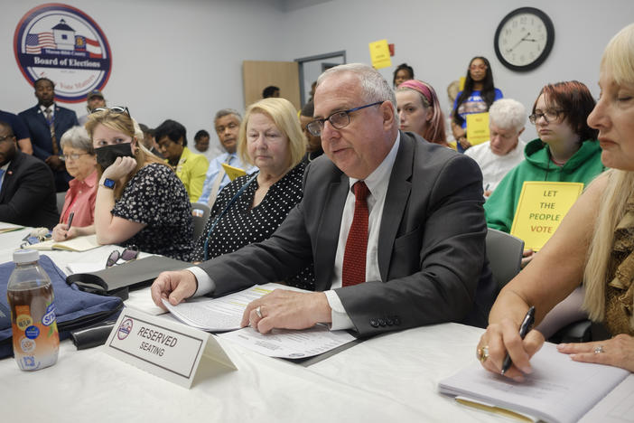 David Sumrall, second from right, presents his case to purge nearly 800 voters from Bibb County voter rolls in May. 