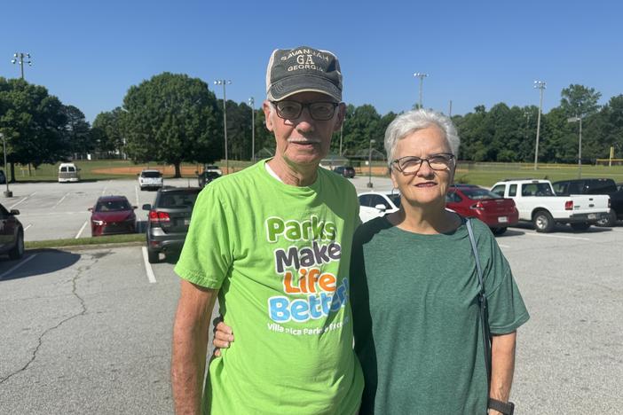 Danny and Lane Camp are shown in a parking lot in this posed photo.