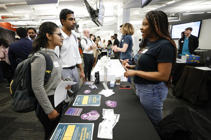 Georgia State University students Kavita Javalagi, left, and Gana Natarajan, second from left, speak with Shetundra Pinkston, during the Startup Student Connection job fair, Wednesday, March 29, 2023, in Atlanta. Students applying to Georgia State and three other public universities in the state beginning in the fall of 2026 will have to start submitting SAT or ACT scores.