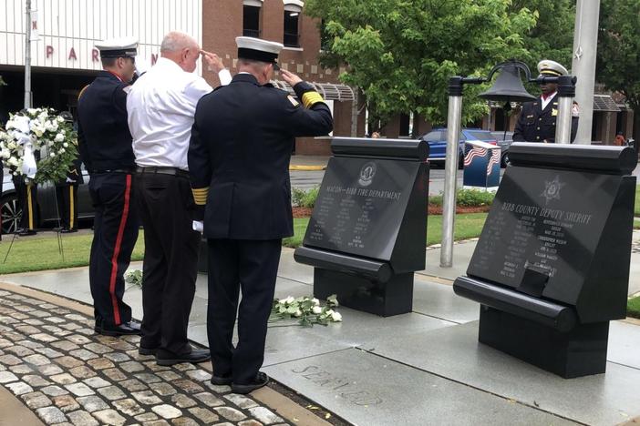 Representatives of the Macon-Bibb County Fire Department salute fallen firefighters, including W.B. Norton who died in 1926.