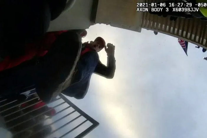 Body camera footage shows men around barricades.