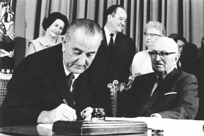 President Lyndon B. Johnson signs the Medicare bill in Independence, Mo., July 30, 1965. At right is former President Harry Truman. The Supreme Court's pending Idaho abortion ruling may hinge on how federal spending power might protect doctors against a state's criminal code. For guidance, the justices can look to the very beginning of Medicare in the 1960s, when the promise of federal funding finally persuaded hospitals in the Jim Crow South to desegregate.