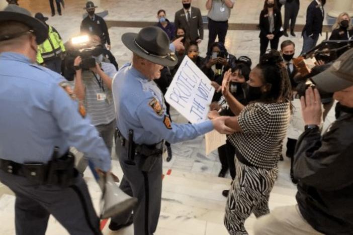 Rep. Park Cannon is confronted by a state trooper in the Capitol rotunda in February 2021, a separate incident from her arrest the following month. The Georgia Supreme Court is set to decide on a case over Georgians’ right to demonstrate inside the Capitol.
