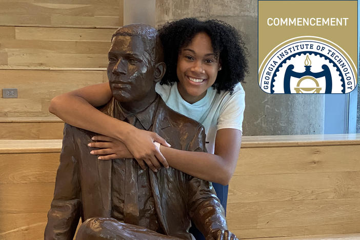 Deanna Yancey poses with a statue of her grandfather, Ronal Yancey, who became the first Black graduate of the university in 1965. Deanna earned her master's degree from Georgia Tech in May 2024.