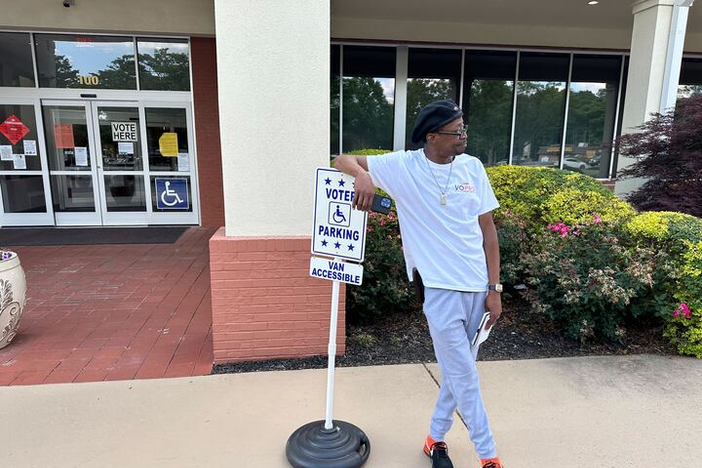 Lamont Hart, a voter protection volunteer for the New Georgia Project, waits to speak with voters outside the Cobb County Senior Wellness Center in Marietta, Ga. He was one of many election monitors during May’s primary. Matt Vasilogambros/Stateline