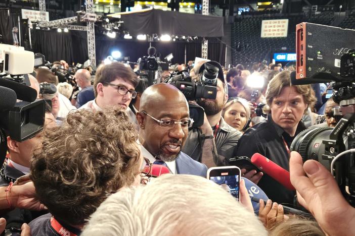 Sen. Raphael Warnock praises President Joe Biden’s debate performance in the spin room at the McCamish Pavilion. Ross Williams/Georgia Recorder.