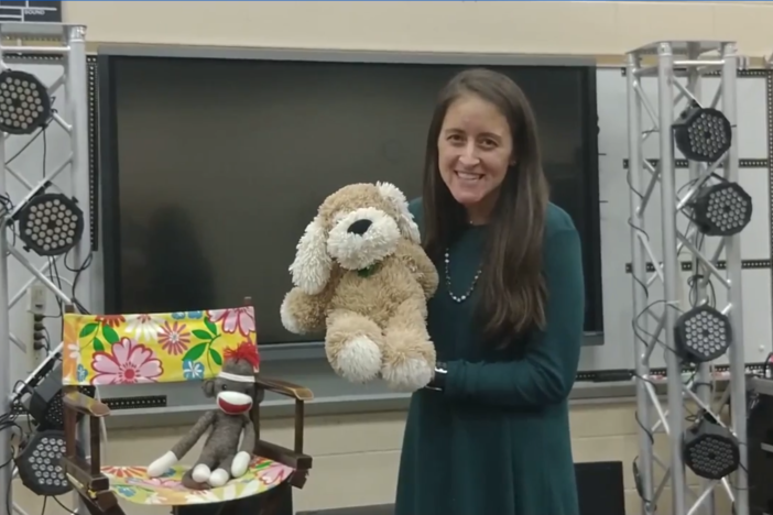 Mrs. Pass holding a puppet dog