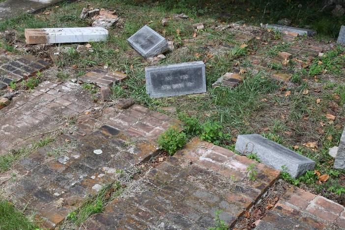 Headstones from the Woolfolk family sit overturned in the Rose Hill Cemetery on Wednesday, July 17, 2024, in Macon, Georgia. The Woolfolk family marker includes nine family members who were murdered in 1887. The area was vandalized this month. Katie Tucker/The Telegraph