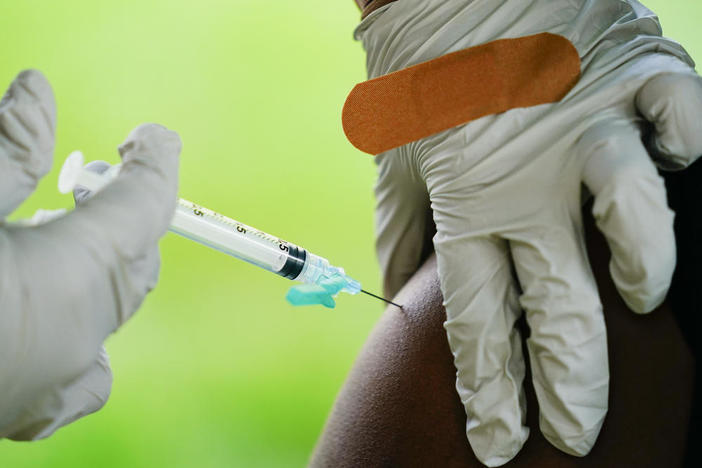 A health worker administers a dose of a Pfizer COVID-19 vaccine during a vaccination clinic at the Reading Area Community College in Reading, Pa., Tuesday, Sept. 14, 2021.