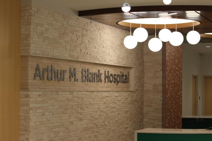 A brick wall with sign that says "Arthur M. Blank Hospital"