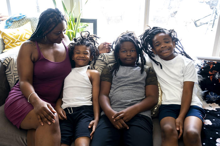 Rasheeda Rahmaan James's sons pose with her for a portrait.