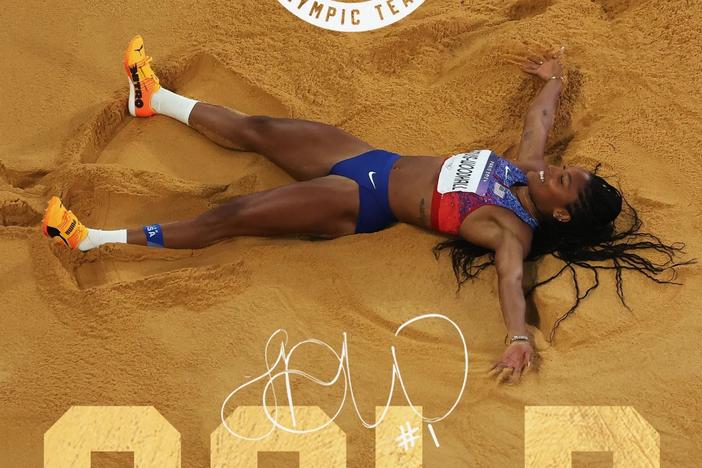  Tara Davis-Woodhall makes a sand angel after winning gold in the long jump. (Credit: @TeamUSA on X)