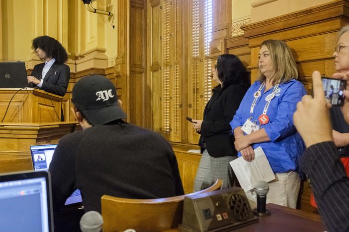 Butts County elections director Brook Schreiner, right, waits for her turn to voice opposition to the election rule changes proposed by the State Board of Elections Friday.  092024_SEB_212.JPG  