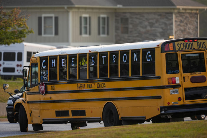 A school bus moves at Apalachee High School, after the school reopened almost three weeks after a deadly shooting on campus, Tuesday, Sept. 24, 2024, in Winder, Ga.