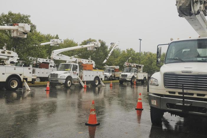 Out of state utility trucks are parked and waiting to be deployed in Macon ahead of Hurricane Helene on Sept. 26, 2024.