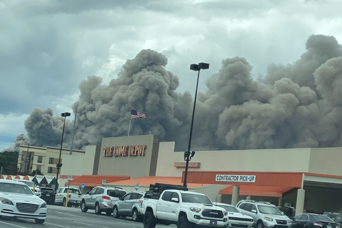 View from a Home Depot parking lot as smoke billows from a fire at the BioLab facility in Conyers, Ga., Sunday, Sept. 29, 2024.