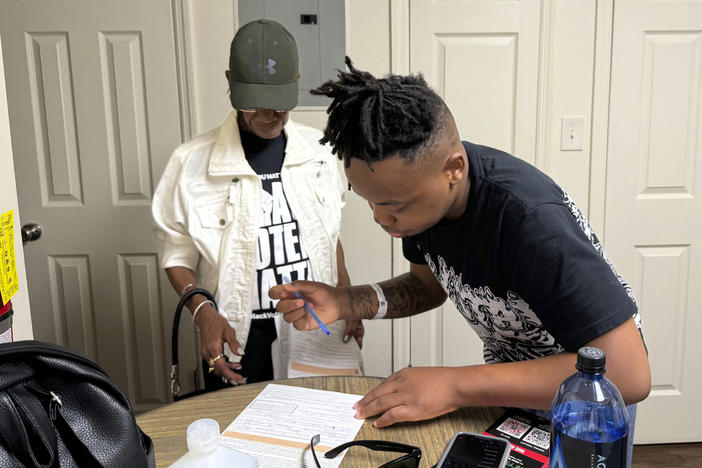 Patricia Powell helps Jaleen Green register to vote in Georgia's Terrell County on Oct. 5, 2024. 