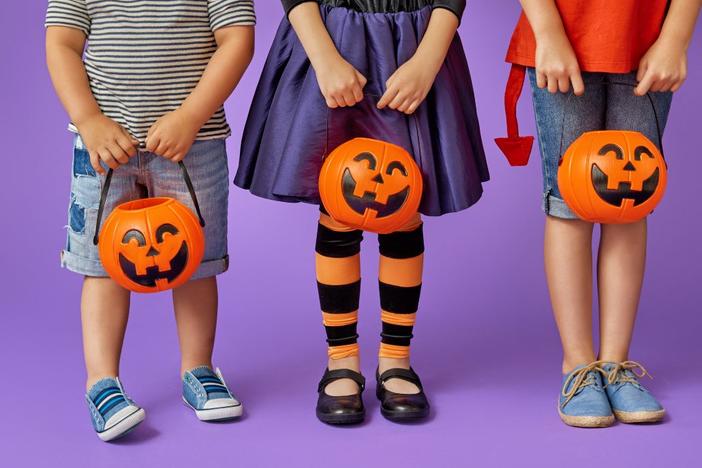 Three children with jack-o-lanterns.
