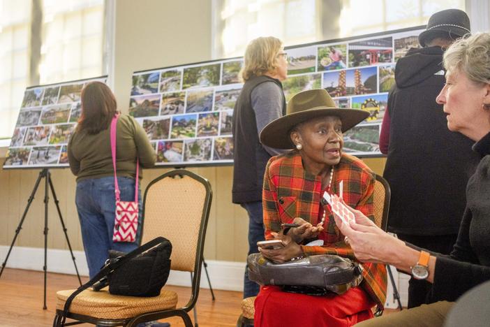 Angel Irving, second from right, talks with Atlanta landscape architect and planner Lauren Standish, right, during a community meeting Thursday about the proposed East Bank redevelopment project at the old Bibb Mill site. Irving said as the project goes forward, she wants assurances that on site jobs are open to local workers.  
