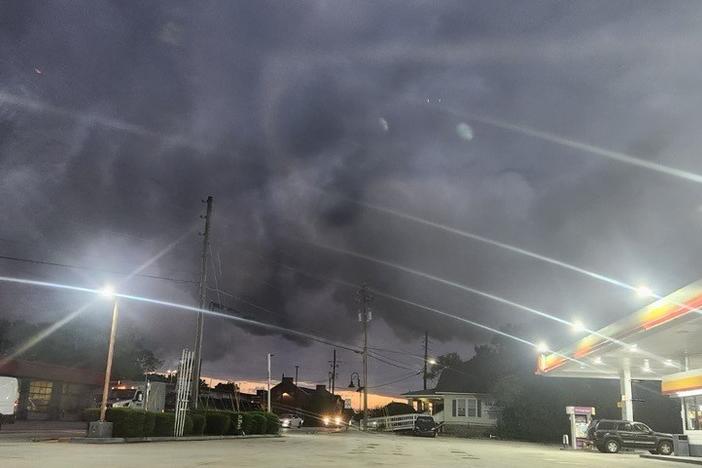 Thick smoke over a nearby gas station in Conyers, Georgia, on September 29 as a chemical fire at the nearby BioLab facility prompts evacuations and raises health concerns among residents