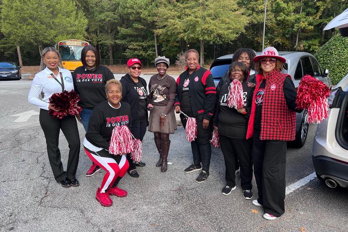 The picture of the women with the red and white pompoms is of NPHC of Dekalb members preparing to cheer newly registered high school students  before they vote.