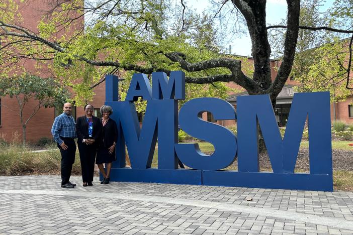 Christopher Ervin, Maisa Standifer and Folashade Omole stand in front of the I Am MSM sign at Morehouse School of Medicine in Atlanta