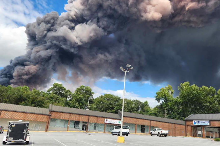 Black smoke billows into the sky above a Conyers shopping plaza as the BioLab chemical fire burns on September 29, 2024.