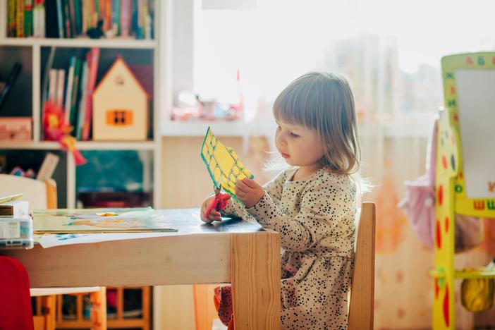 Little Girl Using Scissors. (Pexels)