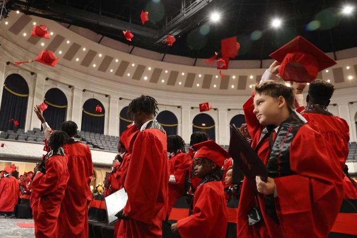 R.I.S.E graduates throw their caps in the air at the R.I.S.E graduation on Thursday, Dec. 19, 2024, at the Macon City Auditorium in Macon, Georgia. Macon Judicial Circuit District Attorney Anita Howard began the Restoring Inspiration by Success in Education initiative in 2022 to support Macon-Bibb County youth impacted by adverse childhood experiences. The number of graduates, or students that completed the program, nearly doubled since 2023. Katie Tucker/The Telegraph 