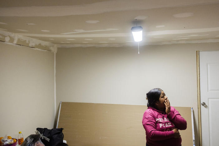 Ana Garcia, a farm worker who lives in South Gerogia, stands in her dining room, newly sheet rocked by her husband in the days after Hurricane Helene. Many farm workers live in trailers or housing that's not fit to weather natural disasters, but because of their legal status, they cannot access help. 