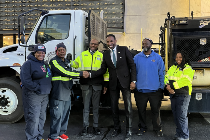 Atlanta Mayor Andre Dickens and ATLDOT Commissioner Solomon Caviness join workers in front of a brine truck on Dec 12, 2024.