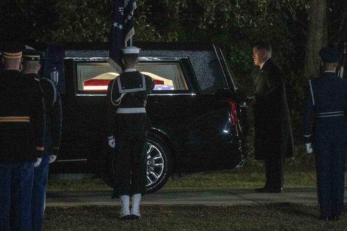 Closing the hearse before carrying Carter to be buried next to his wife Rosalynn on the grounds of their home. 