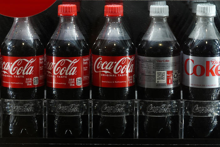 Bottles of Coac Cola chill in a refrigerated case in Coors Field before fans arrive to watch the Seattle Mariners face the Colorado Rockies, April 19, 2024, in Denver. (AP Photo/David Zalubowski, File)