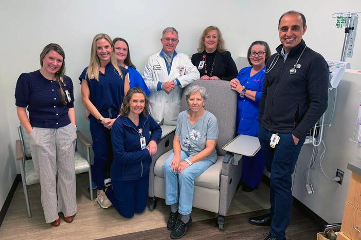 Susan Williams,seated center, a patient at the John B. Amos Cancer Center in Columbus, Georgia, is receiving a new cancer treatment known as Bispecific T-Cell Engager (BiTE) therapies on Feb. 11, 2025. Here, she is photographed with some of her care providers. Credit: Mike Haskey/Columbus Ledger-Enquirer