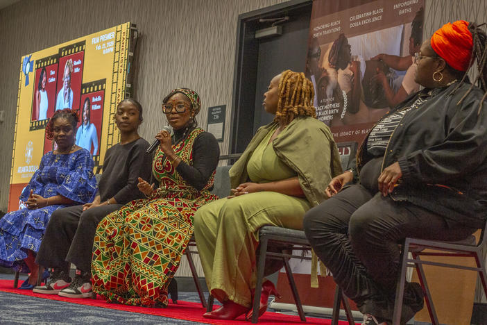 Doula Bashelia Williams, center, and nonprofit founder, Sekesa Berry, far left, sit with other members of the Atlanta Doula Collective featured in "Cradled in Culture: Reclaiming the Legacy of Black Doula Care," during the documentary screening on Feb. 21, 2025, in Atlanta.