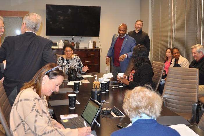 Gwinnett Board of Health members and Gwinnett, Newton, and Rockdale Public Health Department employees speak with each other after the board's meeting in Lawrenceville, Georgia, on Monday. (Allen Siegler / Healthbeat) 