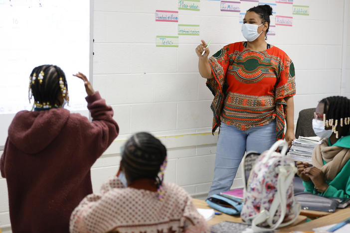 Tashiya Umoja M'kanga, of Atlanta, right, instructs students during a math lesson at the Kilombo Academic and Cultural Institute, March 28, 2023, in Decatur, Ga. (AP Photo/Alex Slitz, File)