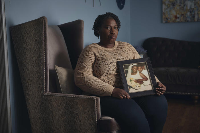 Sharline Volcy holds a wedding picture of her and her deceased husband, Roland Donat's, on Monday, Feb. 3, 2025, in Orange, N.J. 